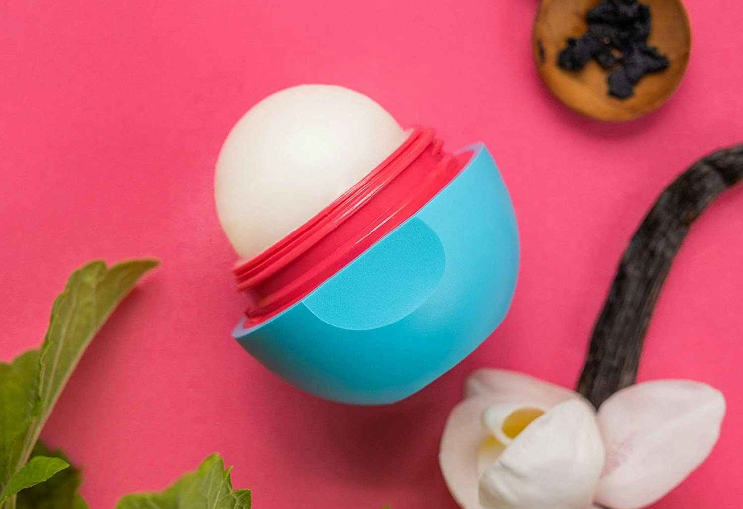 An open container of Eos vanilla-scented lip balm.