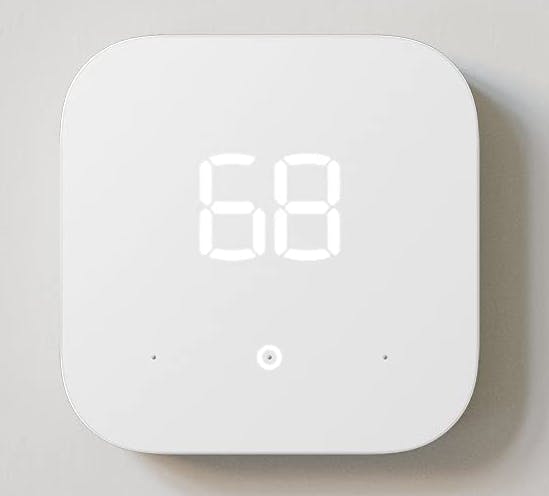 A white Amazon thermostat on a wall.
