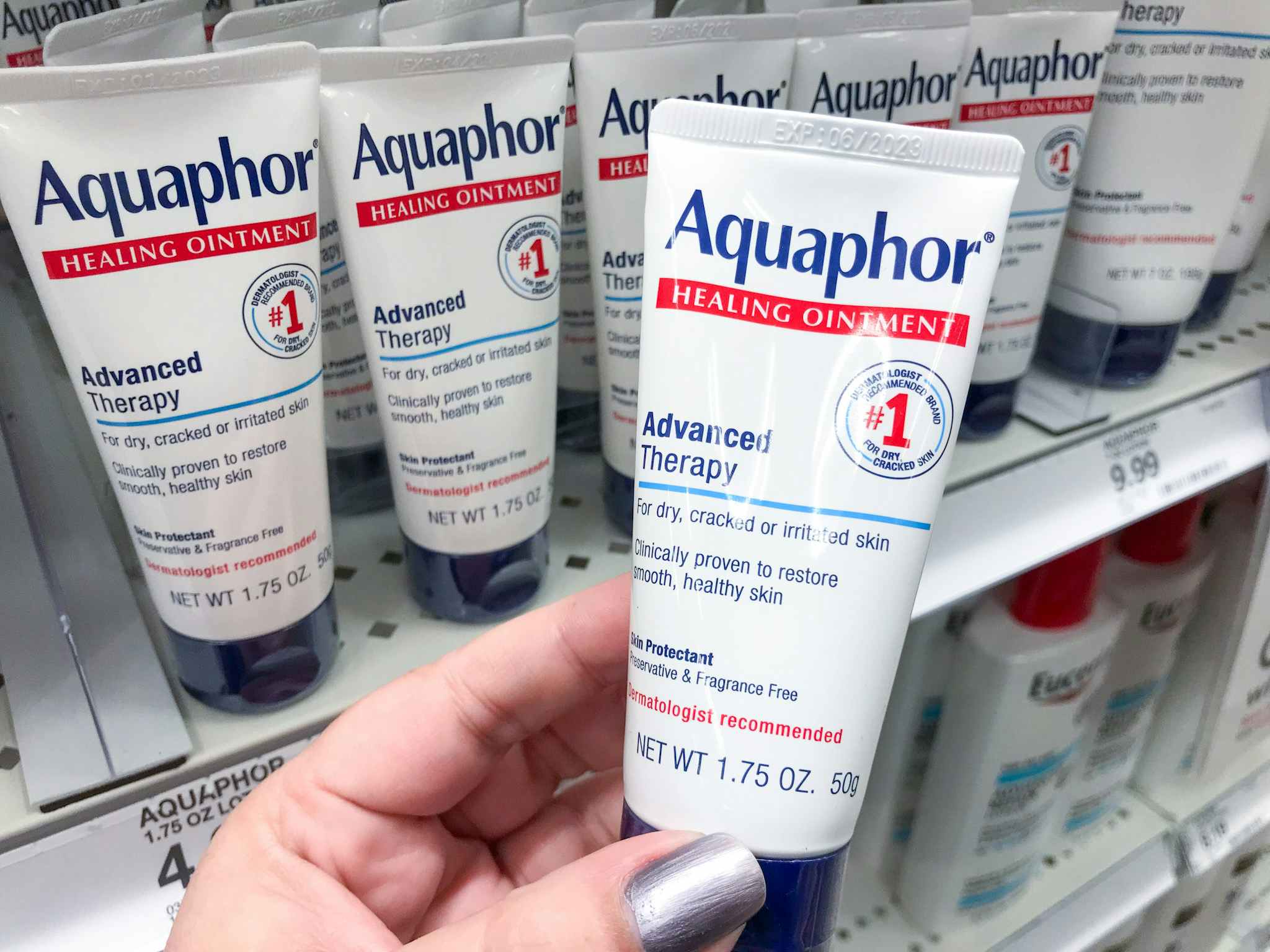 hand holding aquaphor healing ointment at target