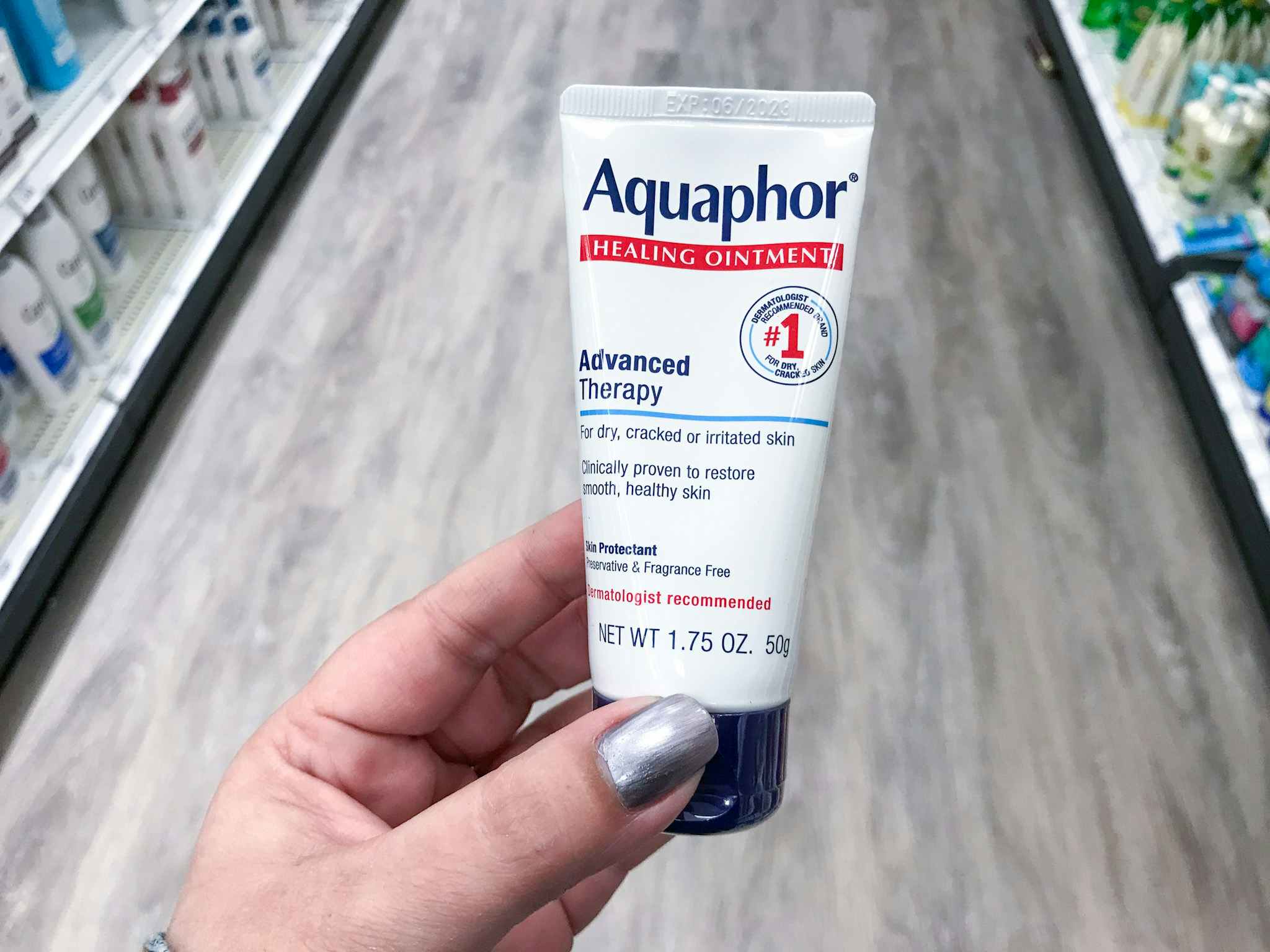 hand holding aquaphor healing ointment at target