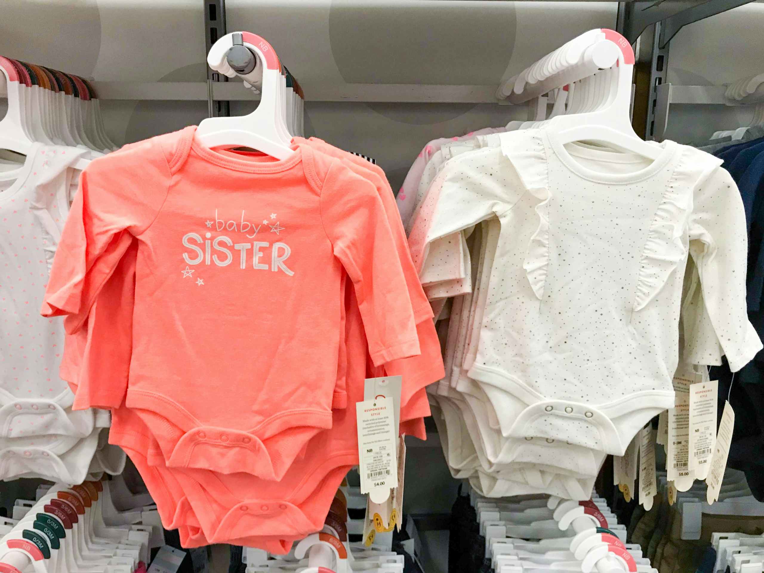 hanging Cat & Jack baby onesies on display at Target