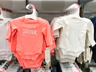 hanging Cat & Jack baby onesies on display at Target