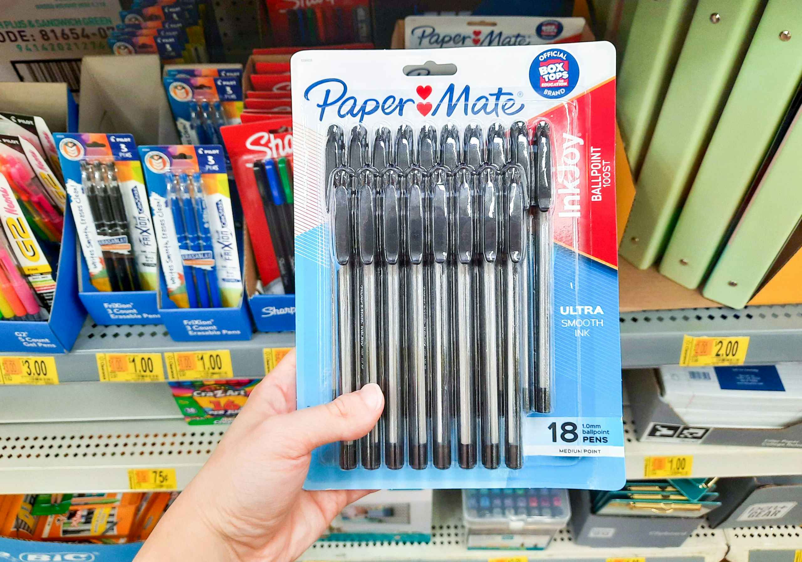 hand holding Paper Mate pens at Walmart