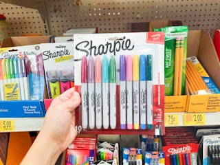 hand holding Sharpie pens at Walmart