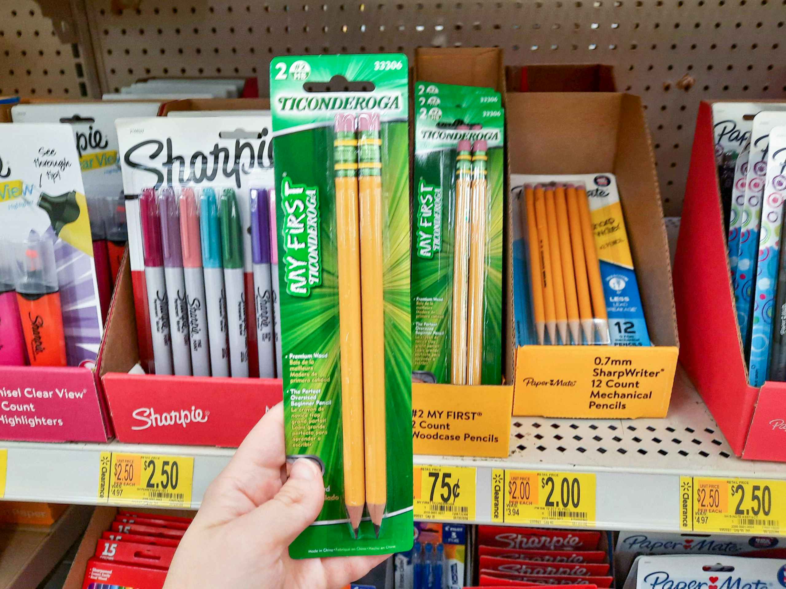 hand holding Ticonderoga pencils at Walmart in front of store shelf