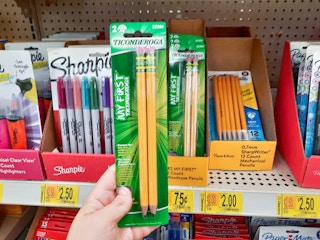 hand holding Ticonderoga pencils at Walmart in front of store shelf