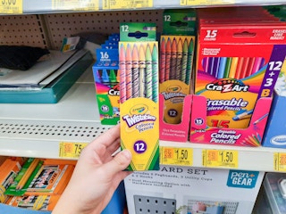 hand holding crayola pencils at Walmart in front of store shelf