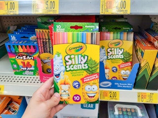 hand holding Crayola pencils at Walmart in front of store shelf