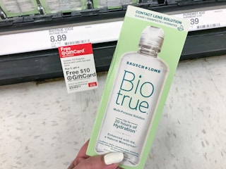 hand holding biotrue contact solution in front of target gift card tag