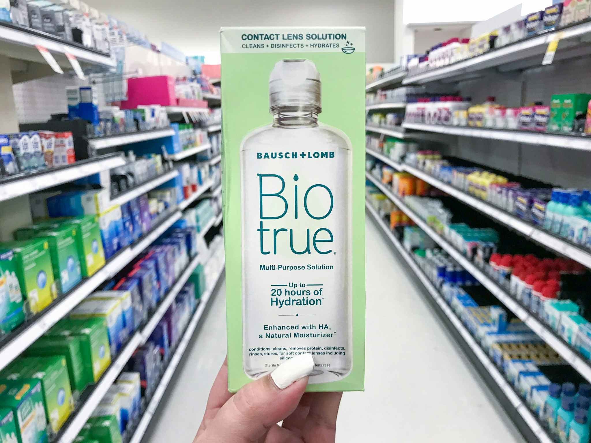 hand holding biotrue contact solution at target