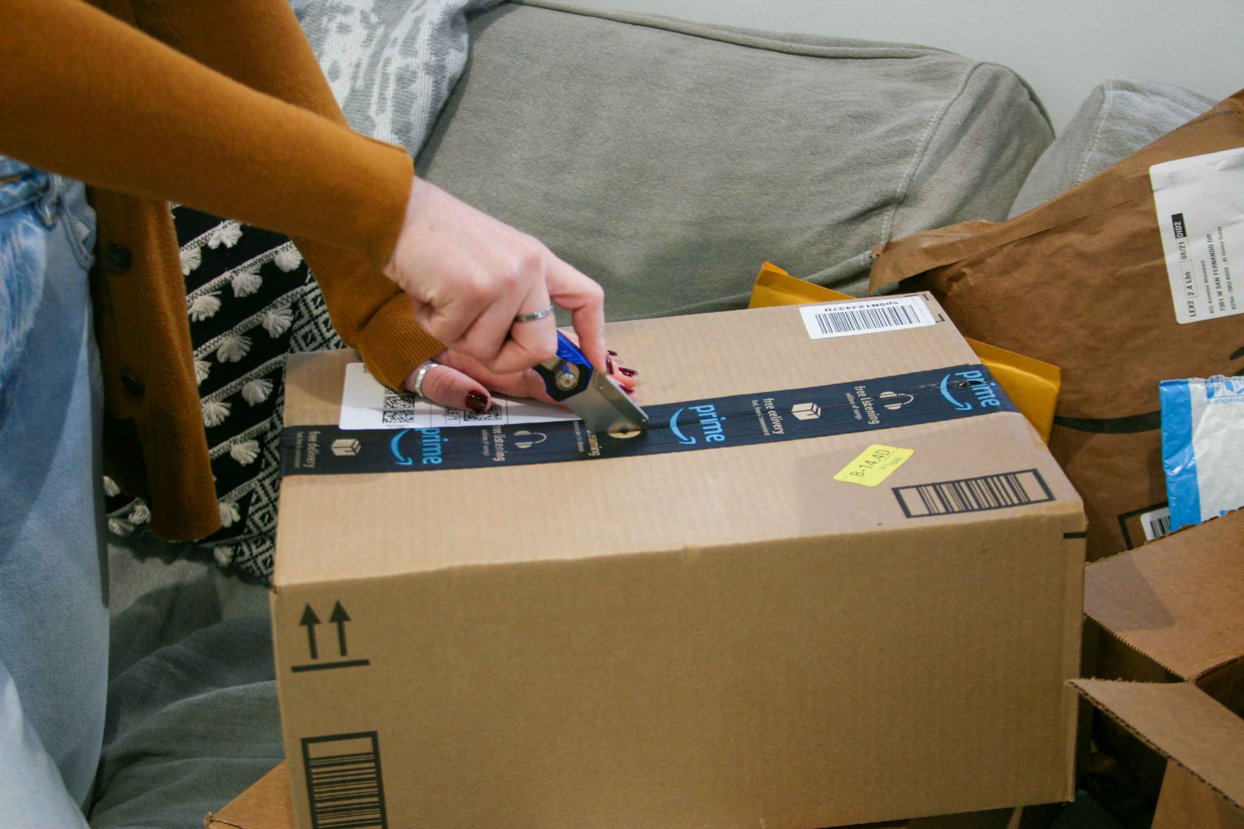 Close up of person cutting open amazon box