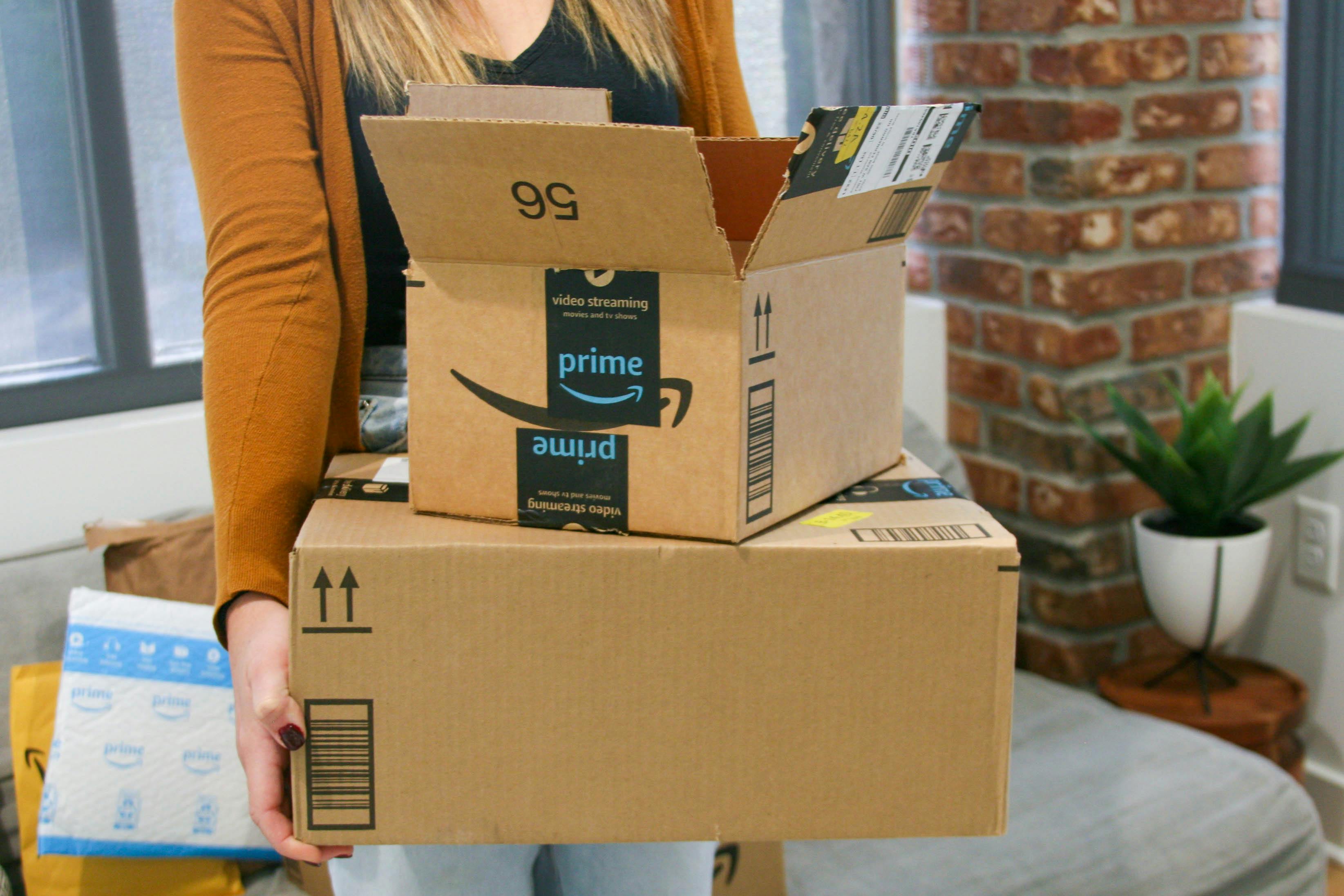 Close up of person cutting open amazon box
