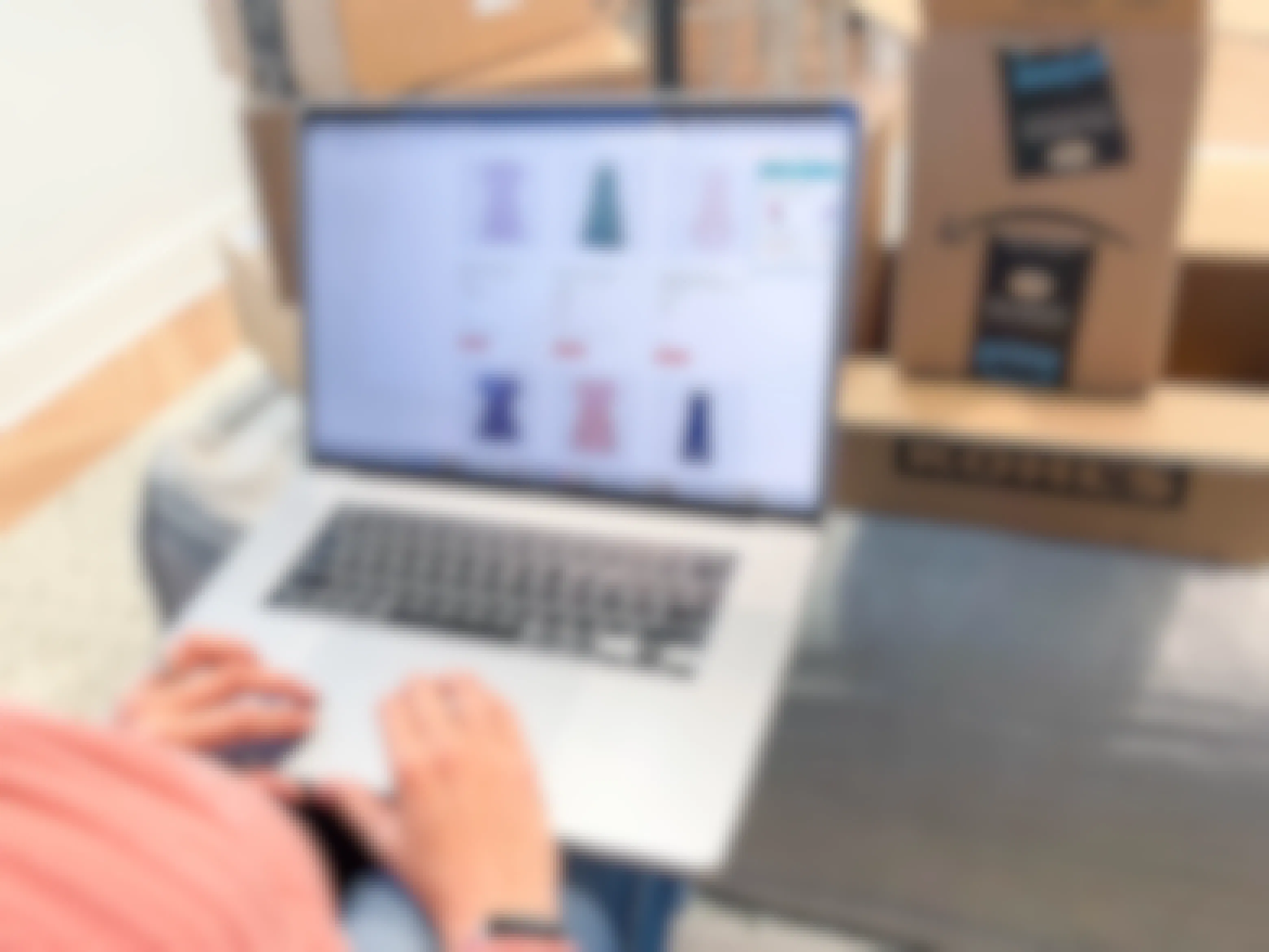 woman online shopping on laptop surrounded by boxes