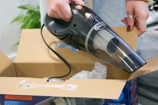 Corded car vacuum next to box