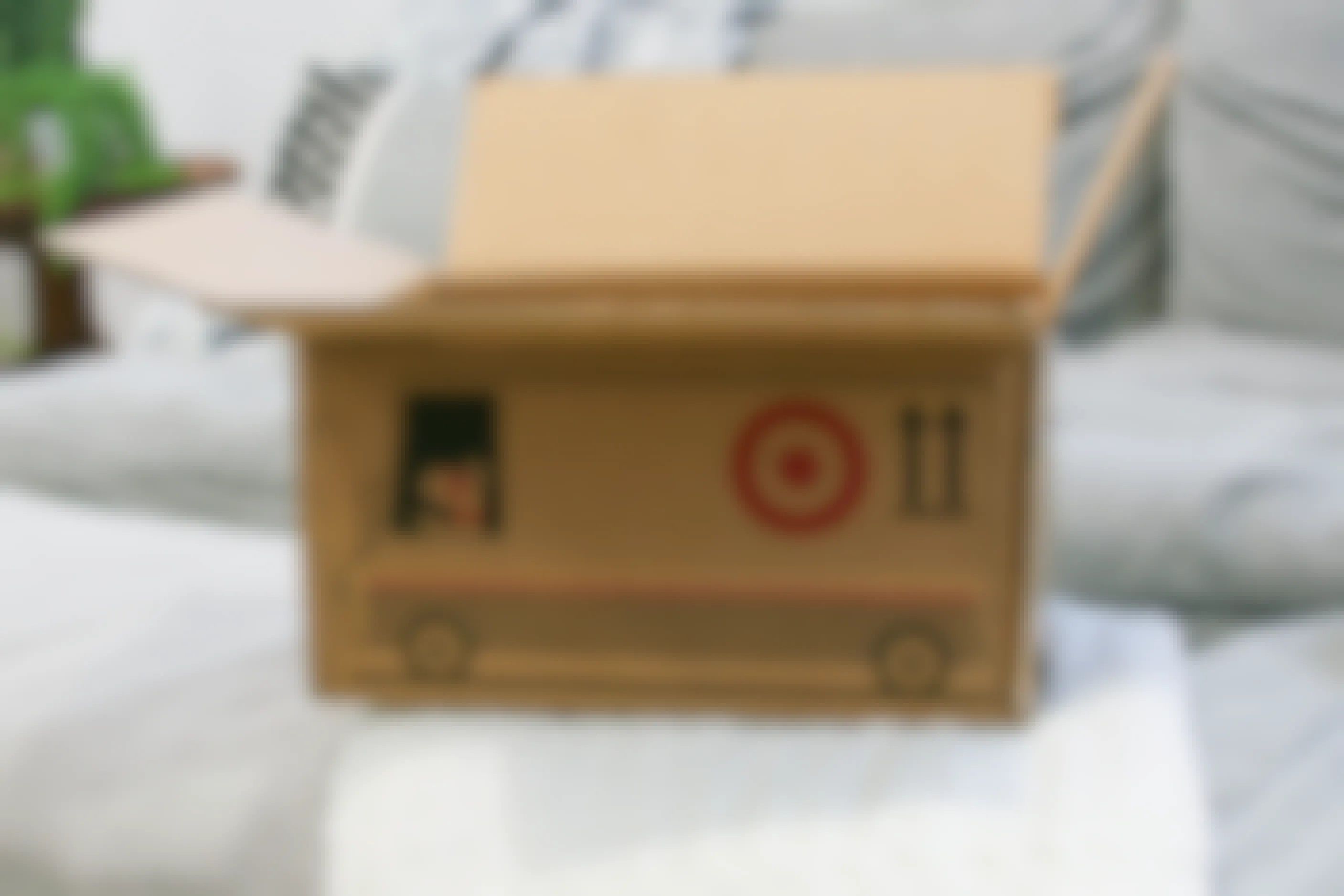 An open Target shipping box sitting on a couch.