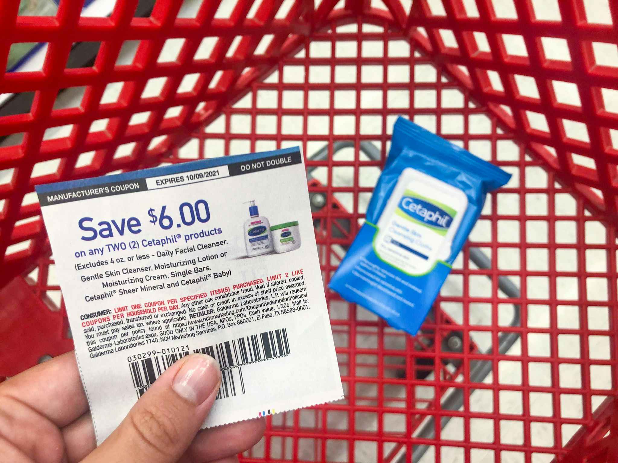 hand holding a cetaphil coupon at target