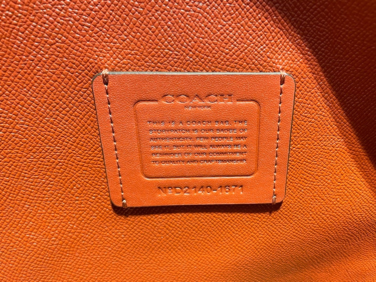 the storypatch badge of authenticity inside an authentic leather coach bag