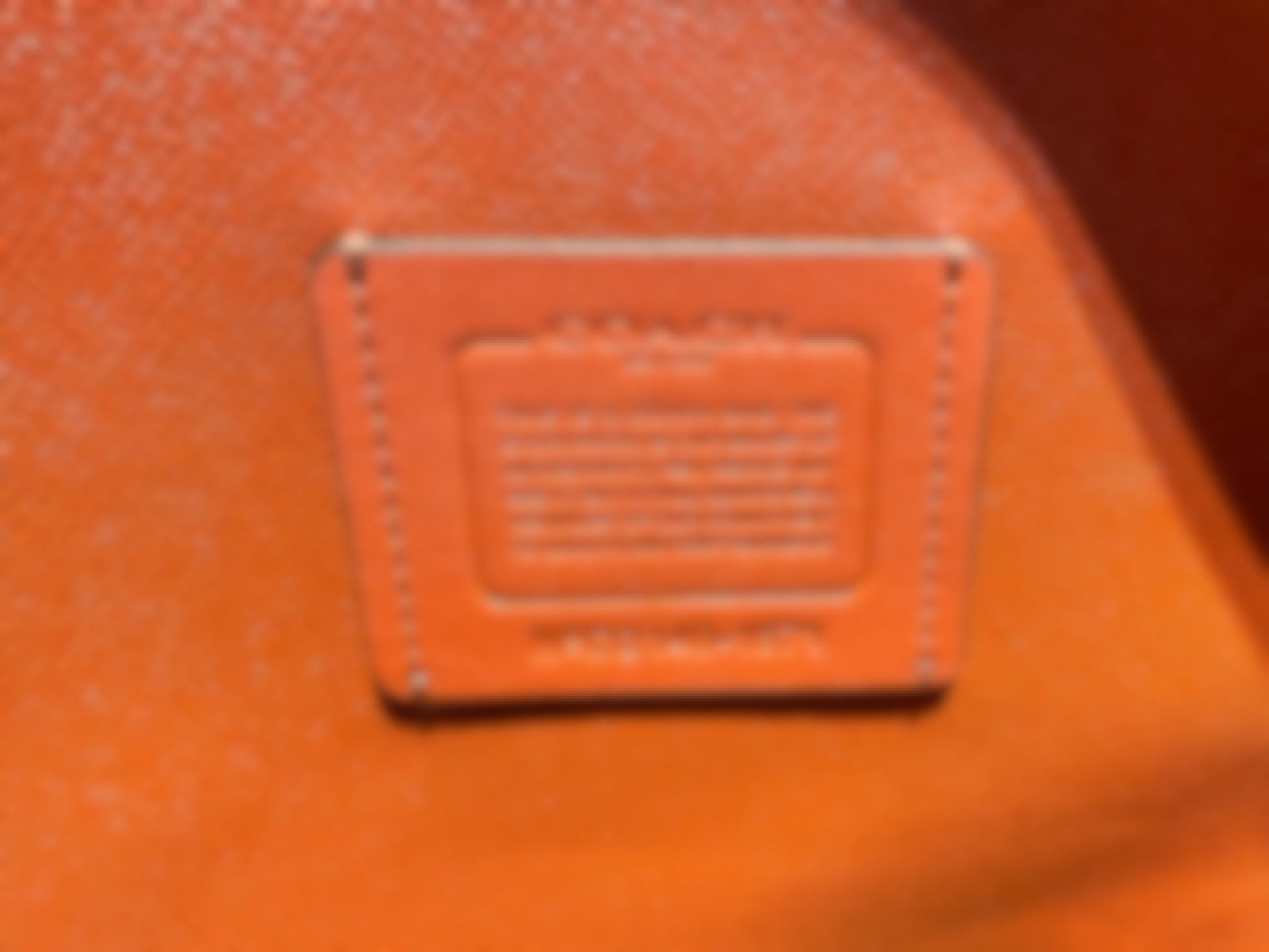 the storypatch badge of authenticity inside an authentic leather coach bag