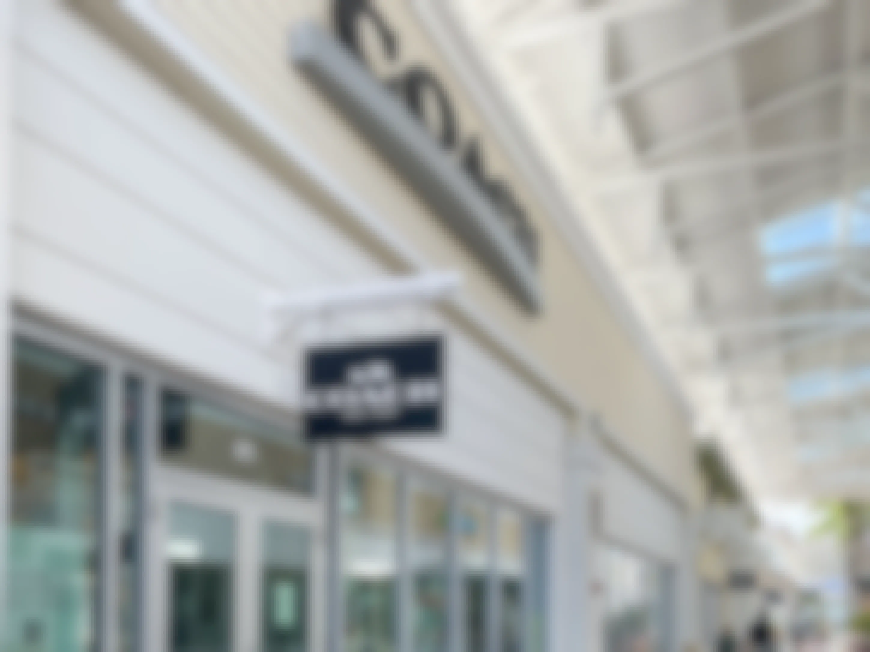 Exterior view of a coach outlet store at an outdoor outlet mall