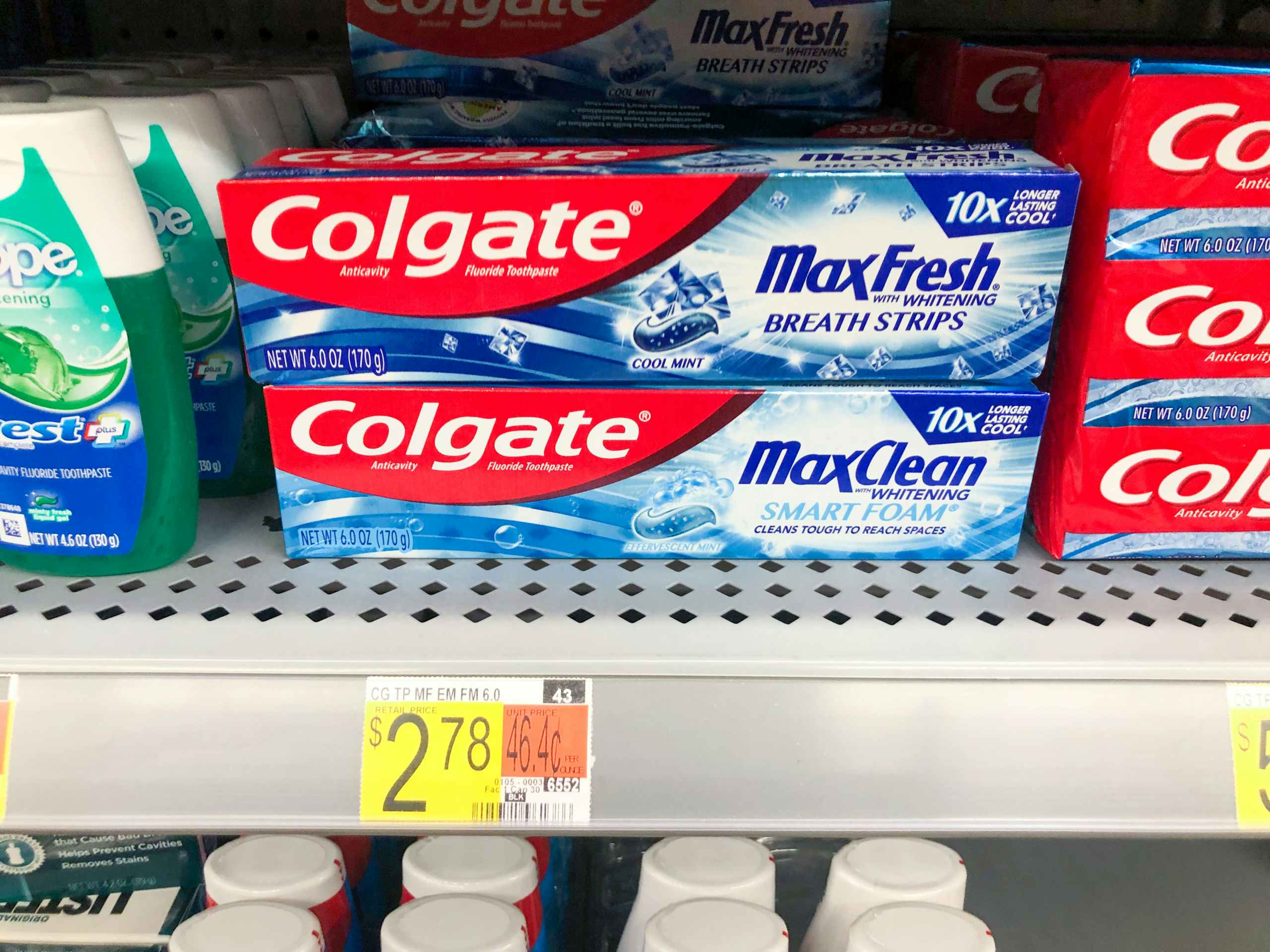 boxes of Colgate toothpaste on Walmart store shelf