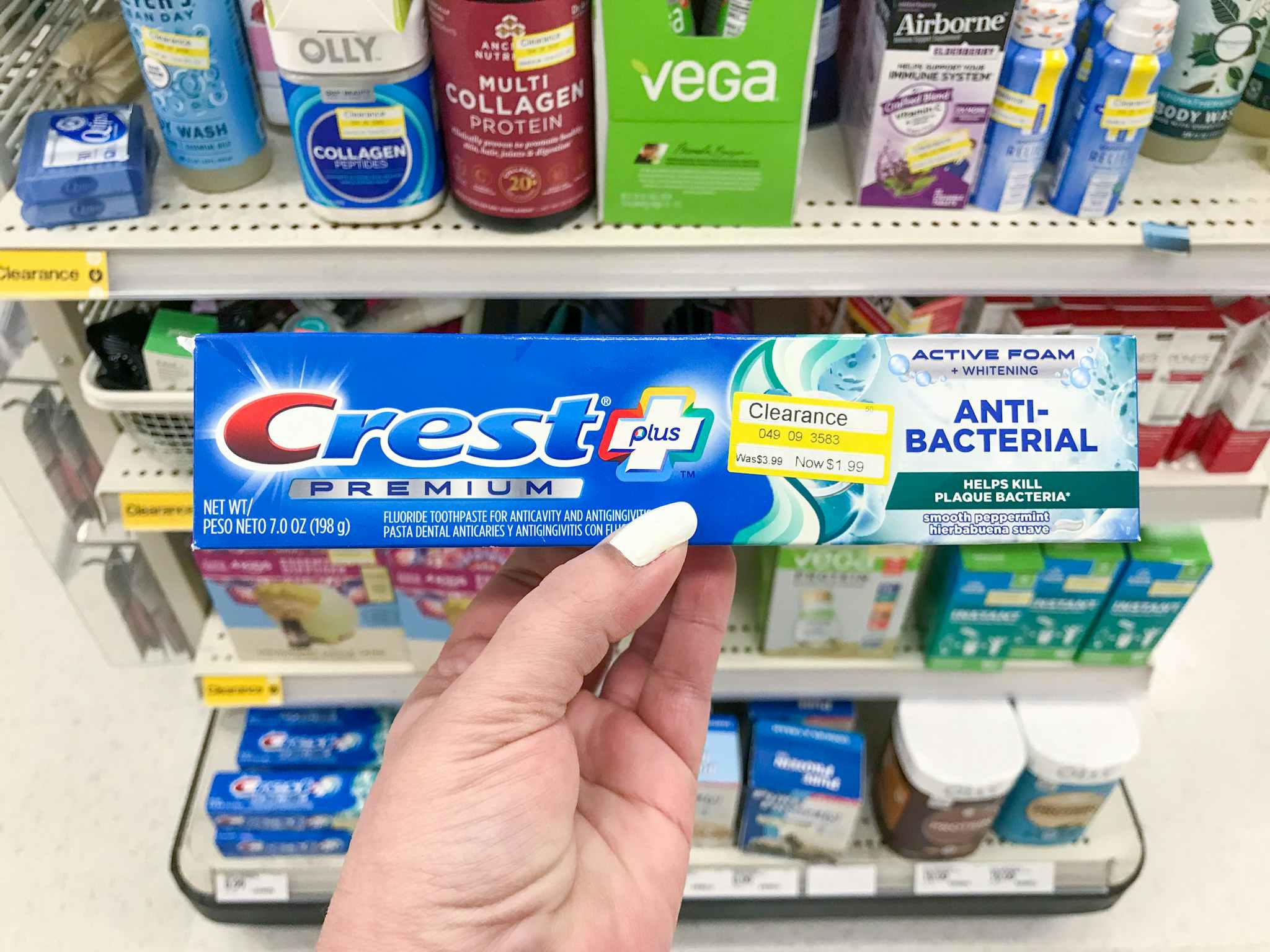 hand holding crest premium toothpaste clearance at target