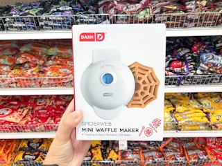 hand holding a dash spider web waffle maker at target