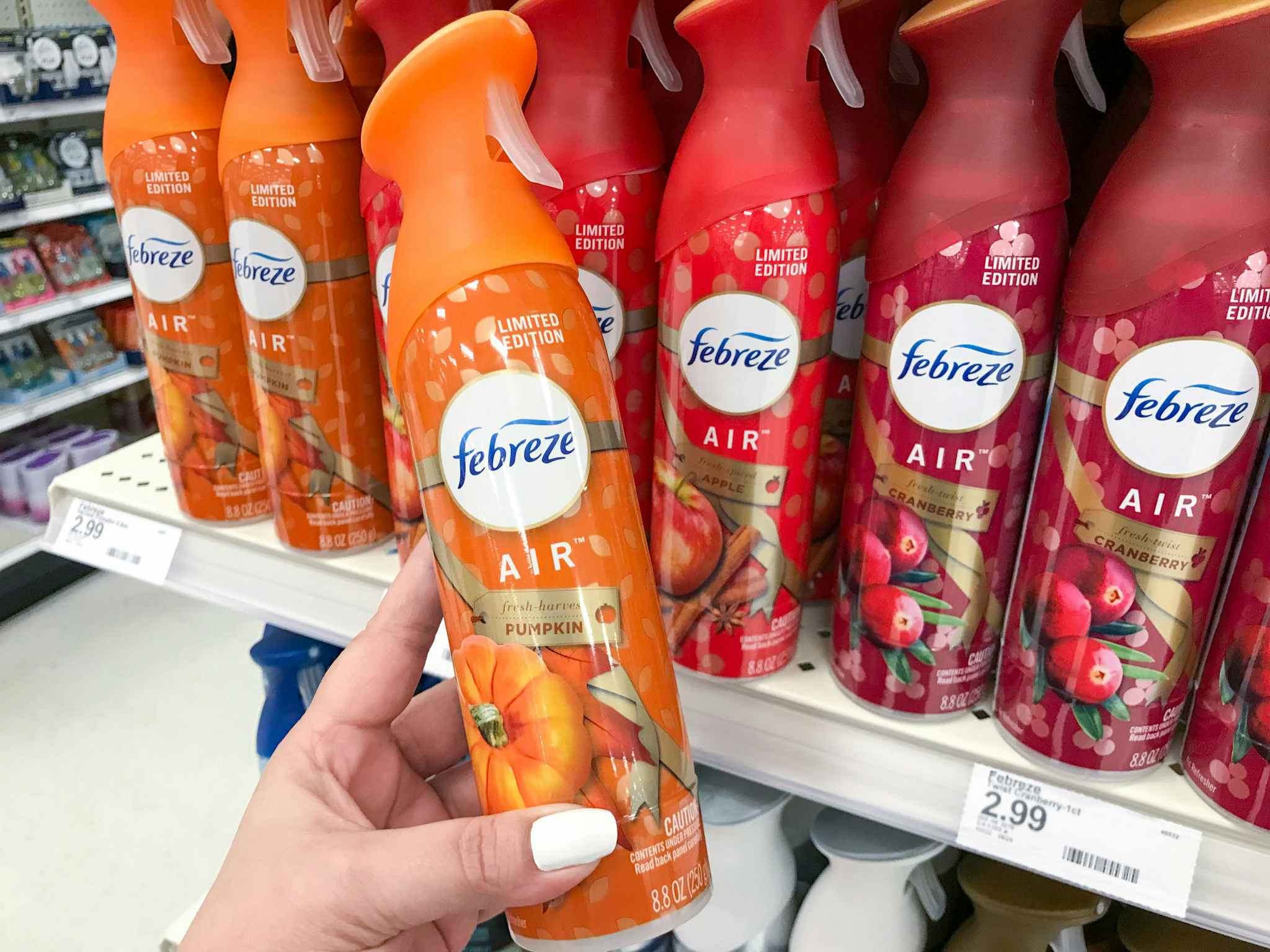 hand holding febreze air freshener spray at target