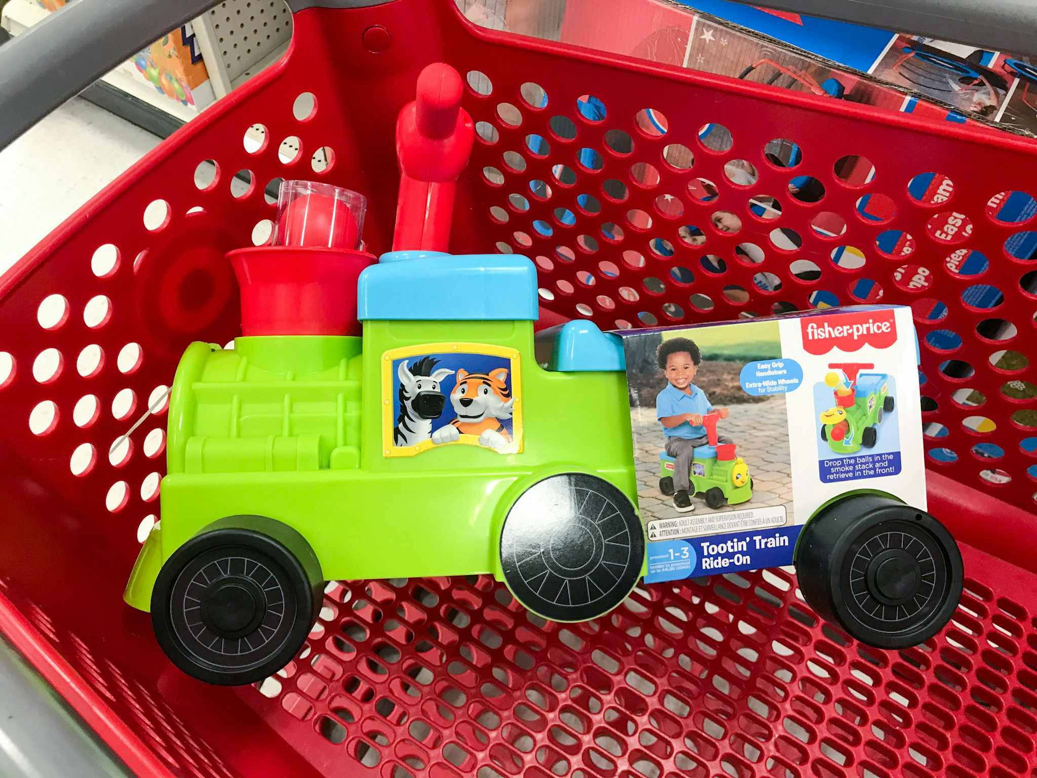 fisher-price train ride-on in a target cart
