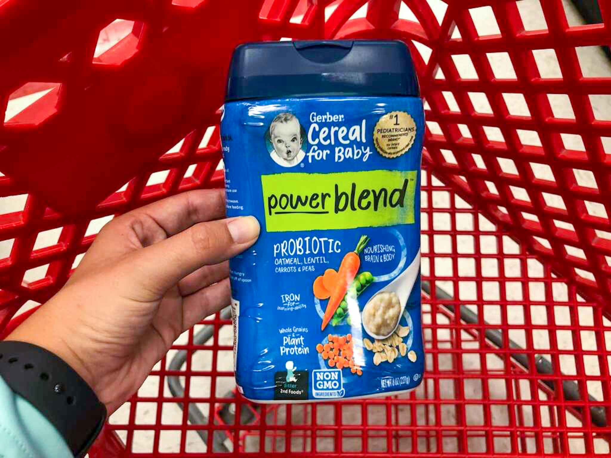 hand holding gerber powerblend cereal over a target cart