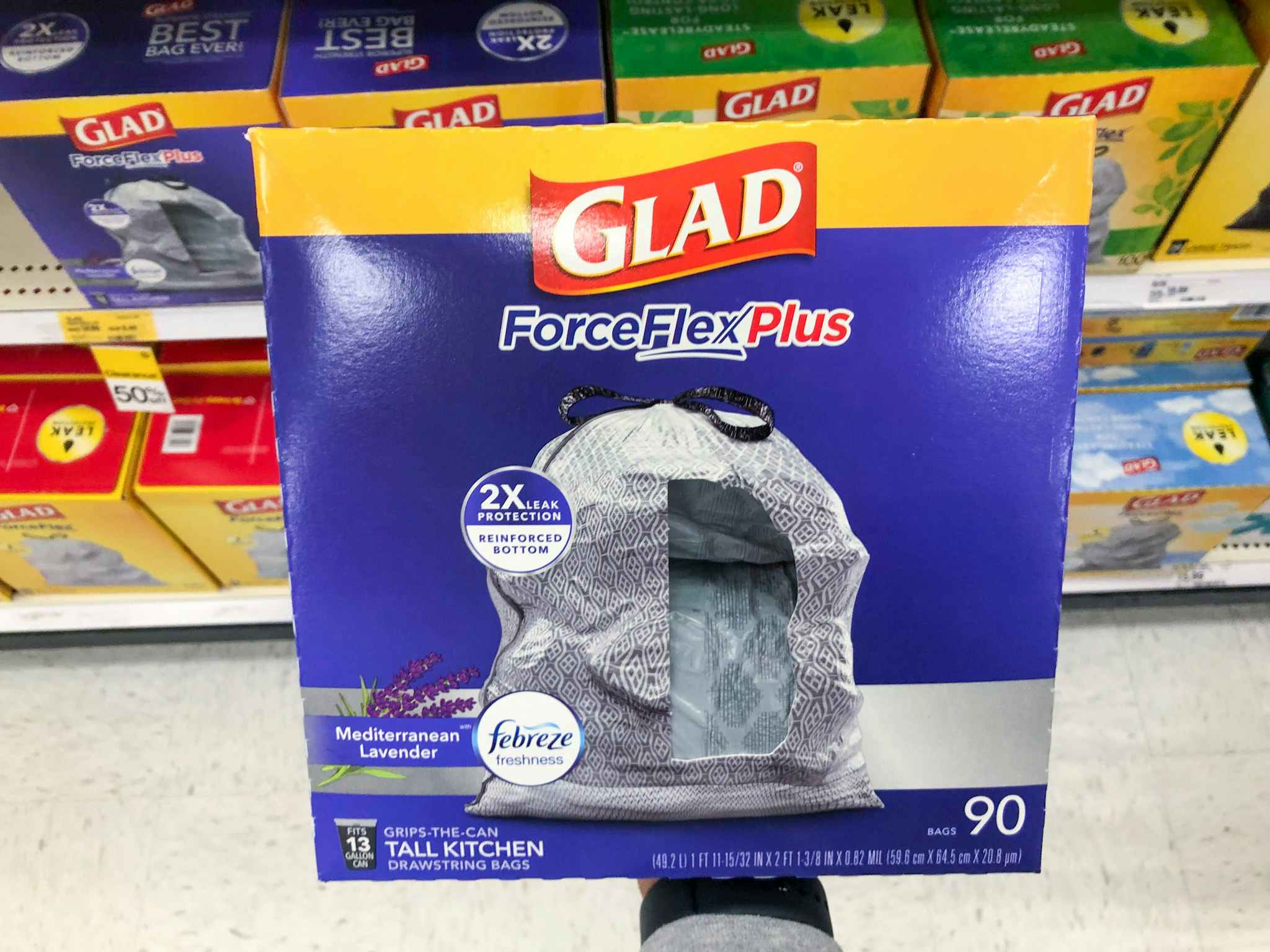 hand holding a box of glad forceflexplus kitchen trash bags at target