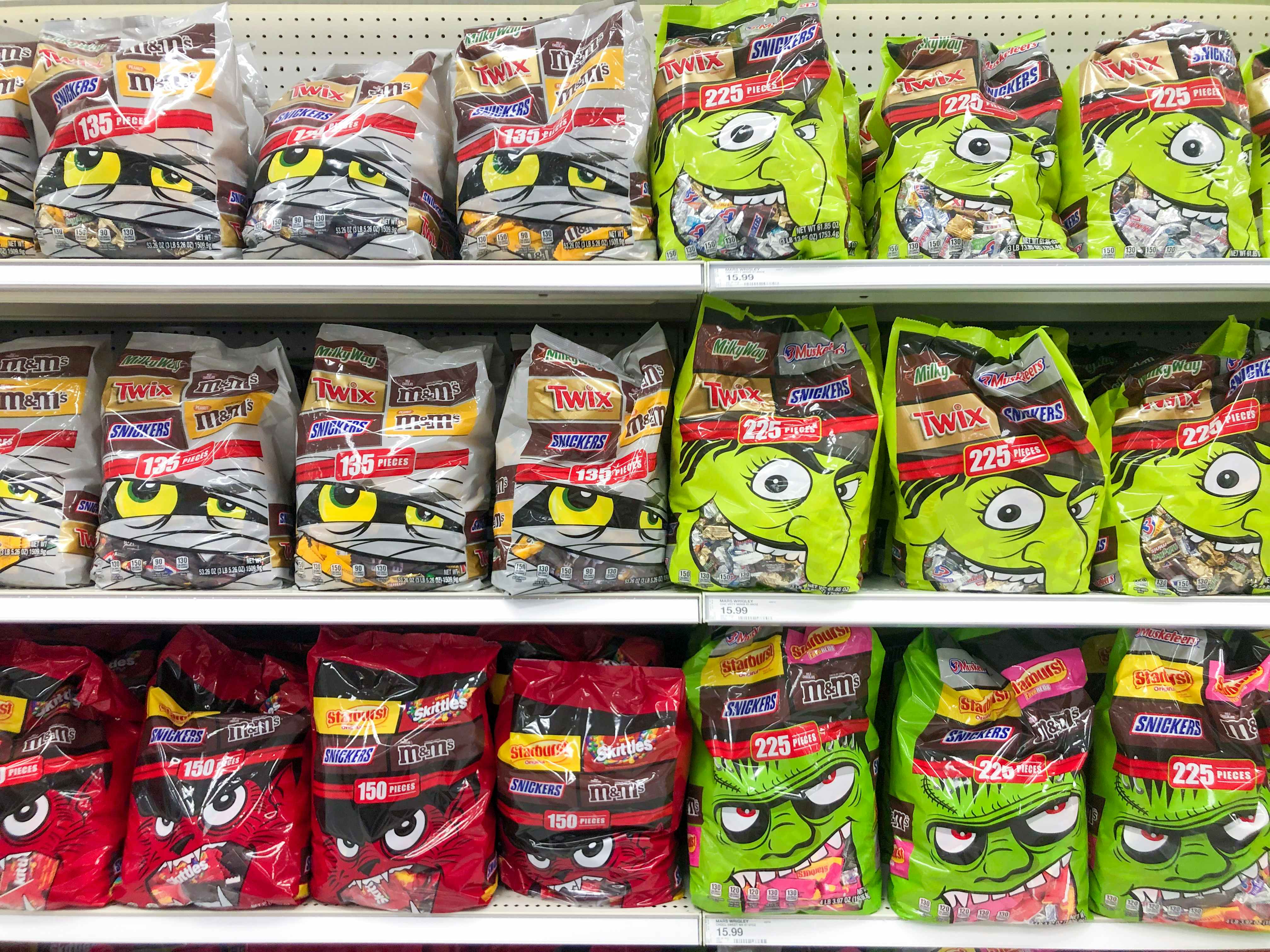 Store shelf of big bags of halloween candy.