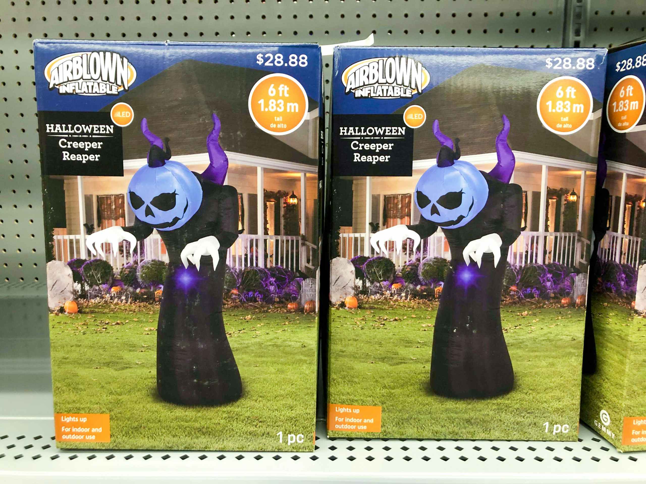inflatable halloween decor in boxes on Walmart shelf