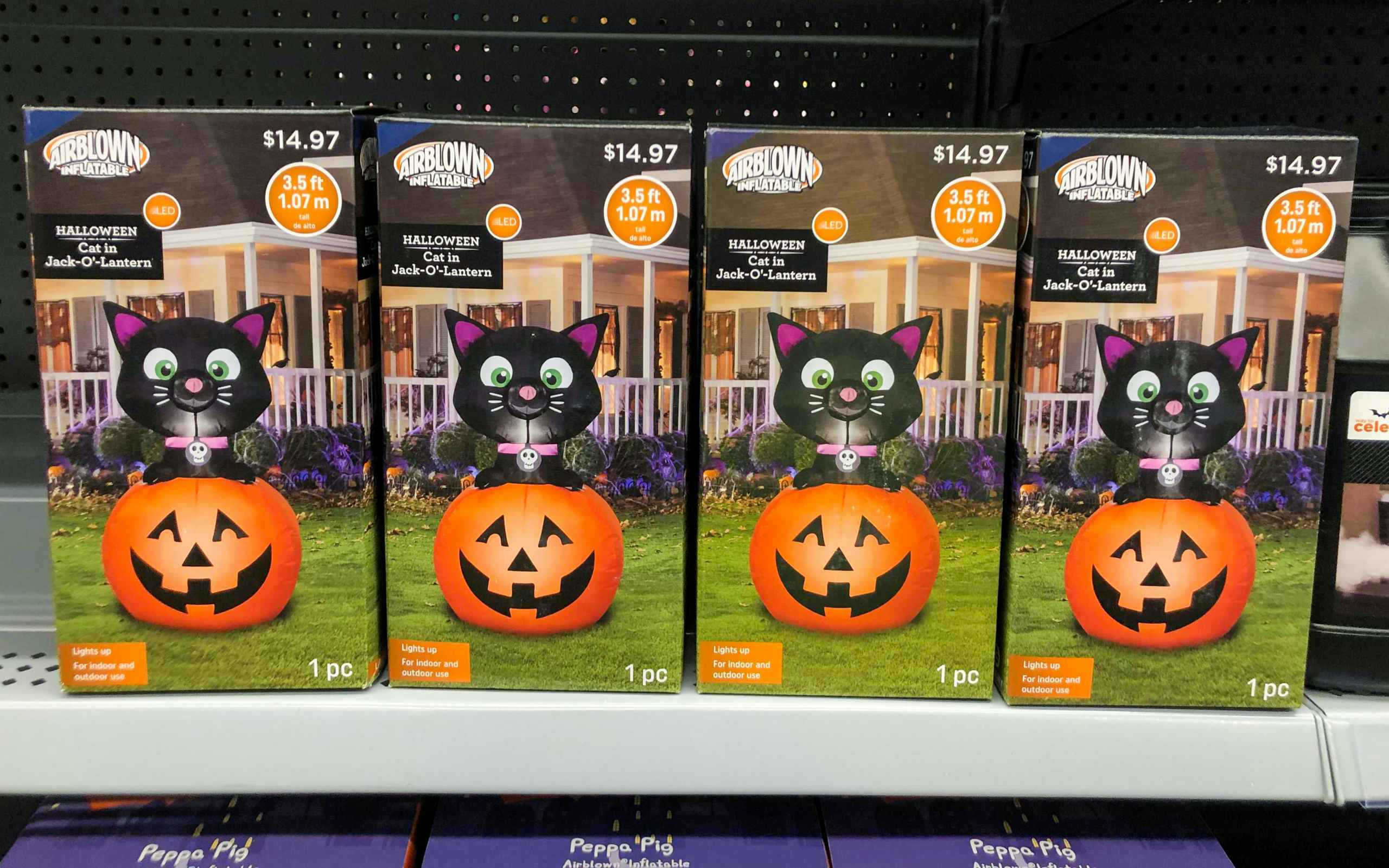 Cat and punpkin inflatable halloween decor in boxes on Walmart shelf