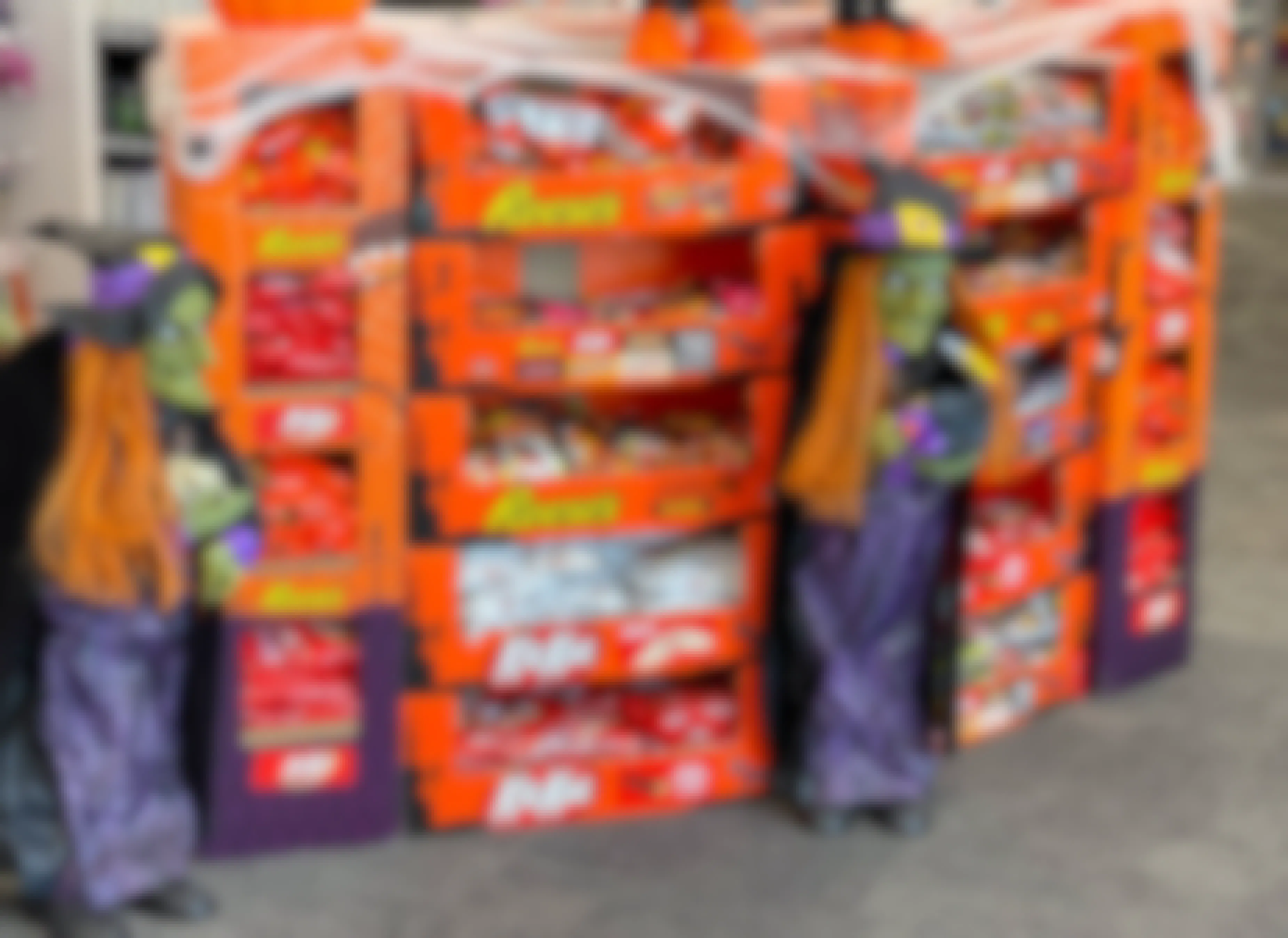 A display of Halloween candy and some witch decorations at a store.