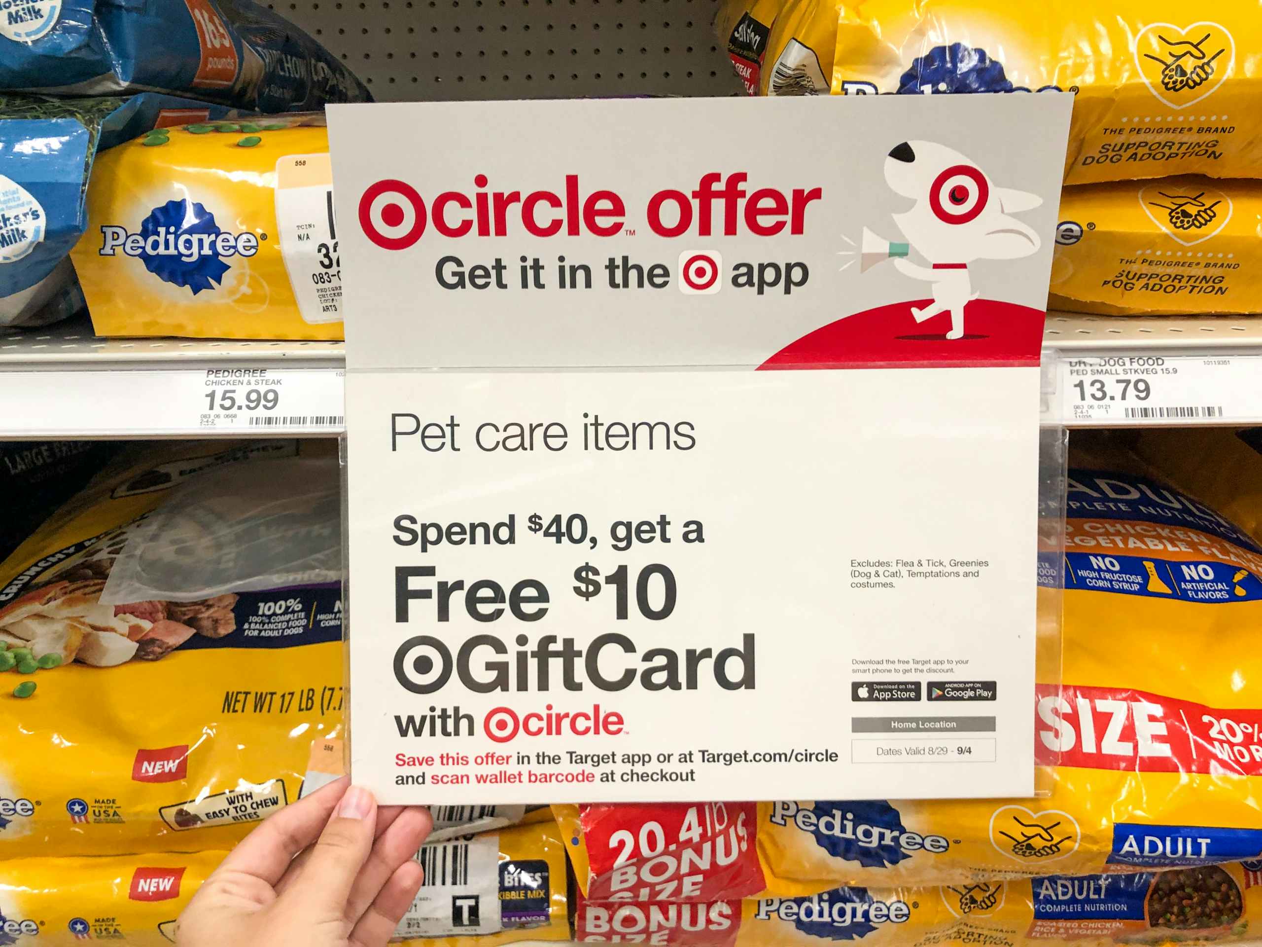 hand holding sign for dog food gift card promotion at Target