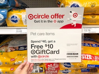 hand holding sign for dog food gift card promotion at Target