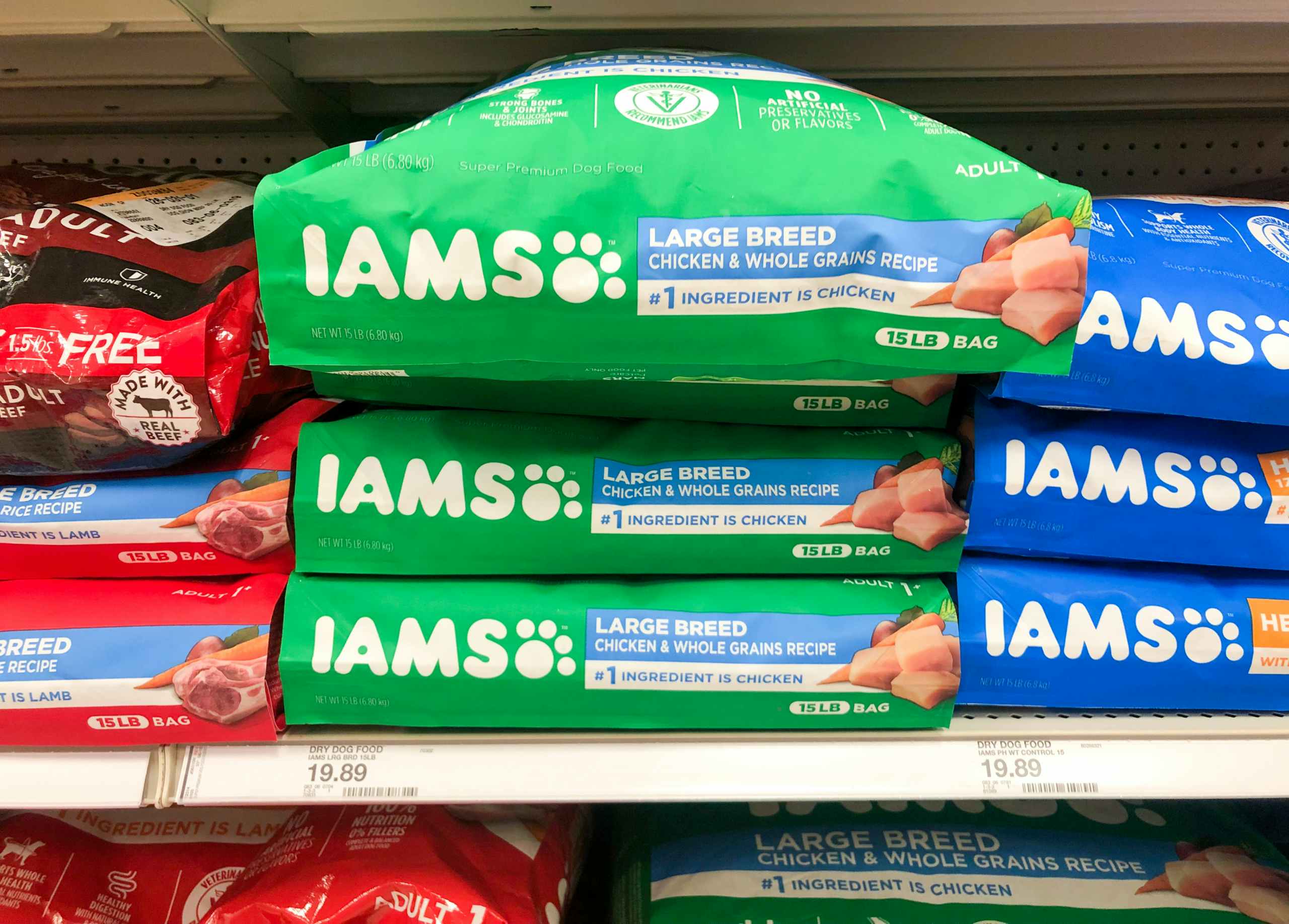 three bags of Iams dog food stacked on store shelf