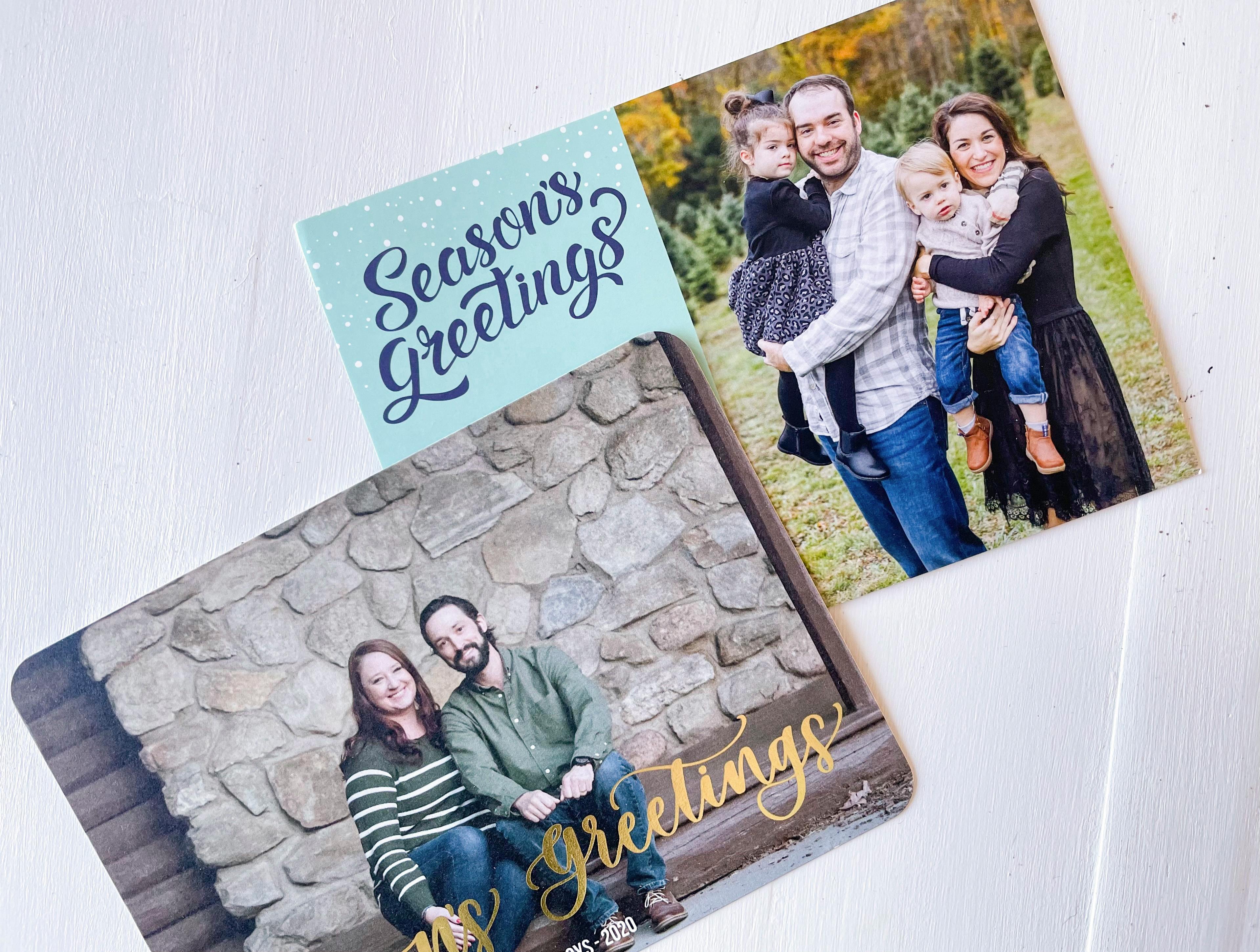 two custom photo holiday cards on white table