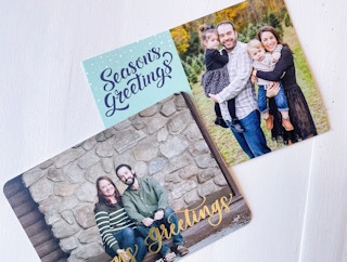 two custom photo holiday cards on white table