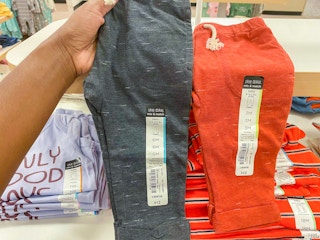 hand holding baby boy fleece pants