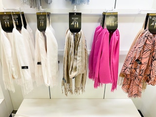 a display of scarfs on hooks