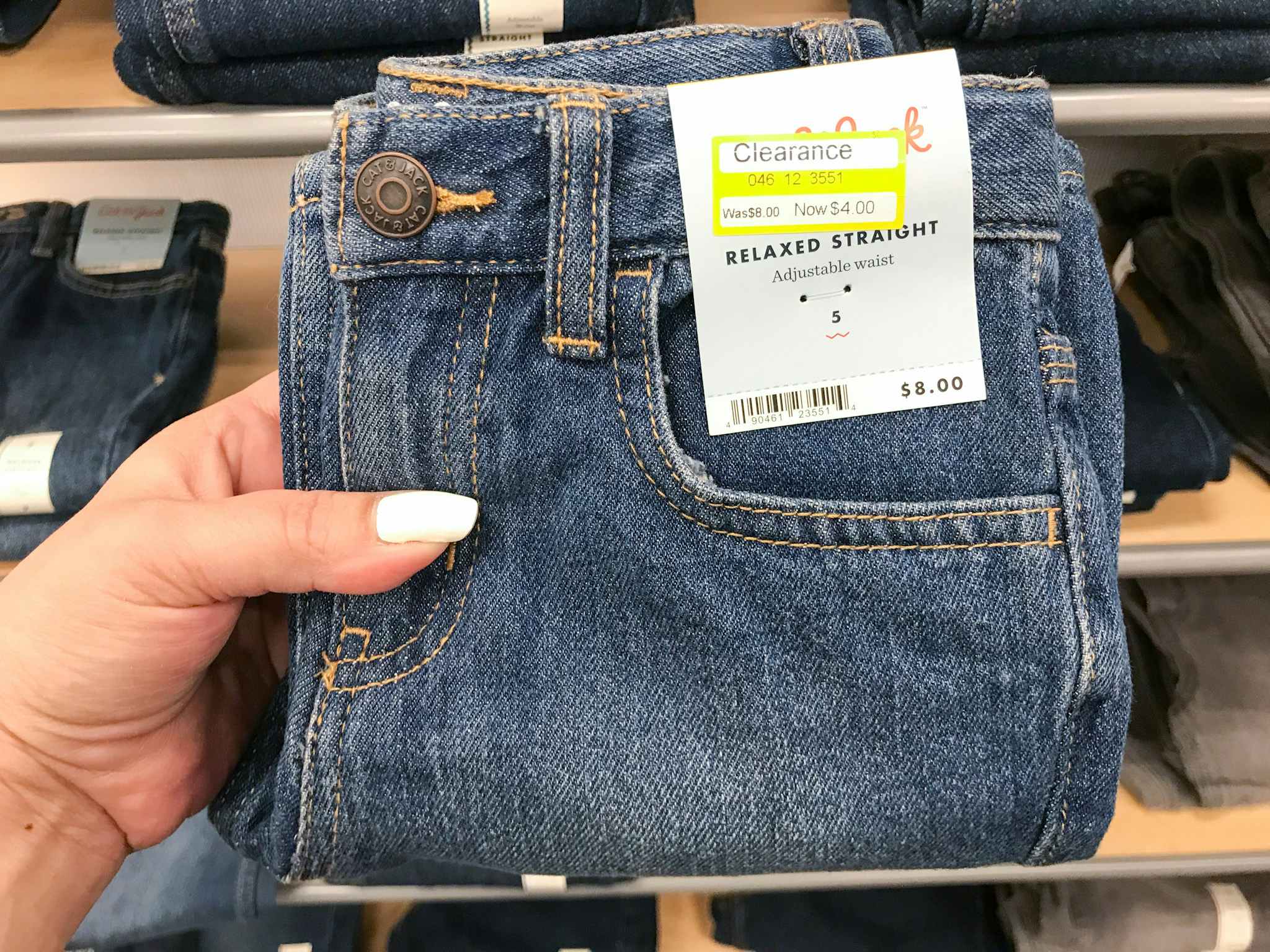 hand holding a pair of cat & jack boys' clearance jeans at target