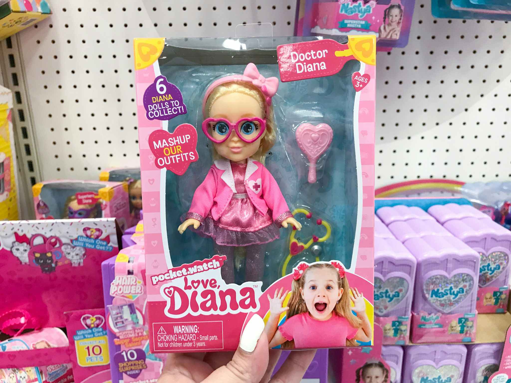 hand holding a love diana doctor diana mashup doll at target