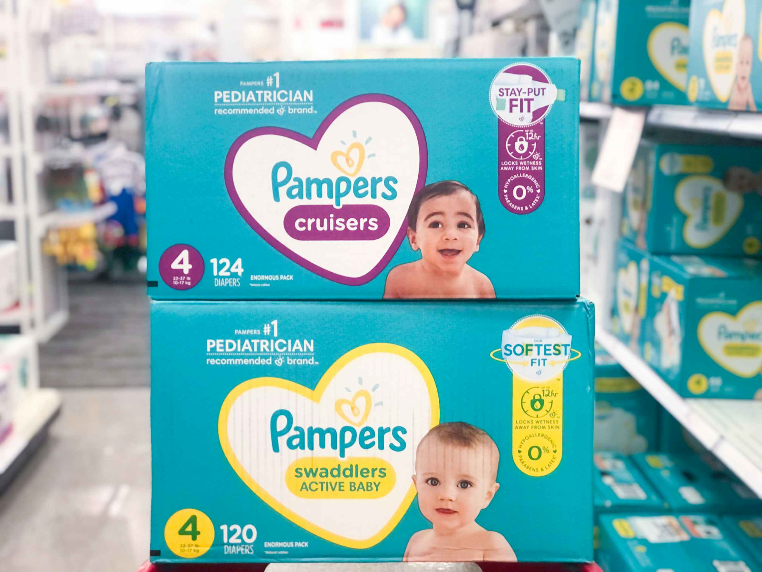 Two boxes of Pampers diapers stacked in an aisle at Target.