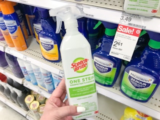 hand holding scotch-brite cleaner at target