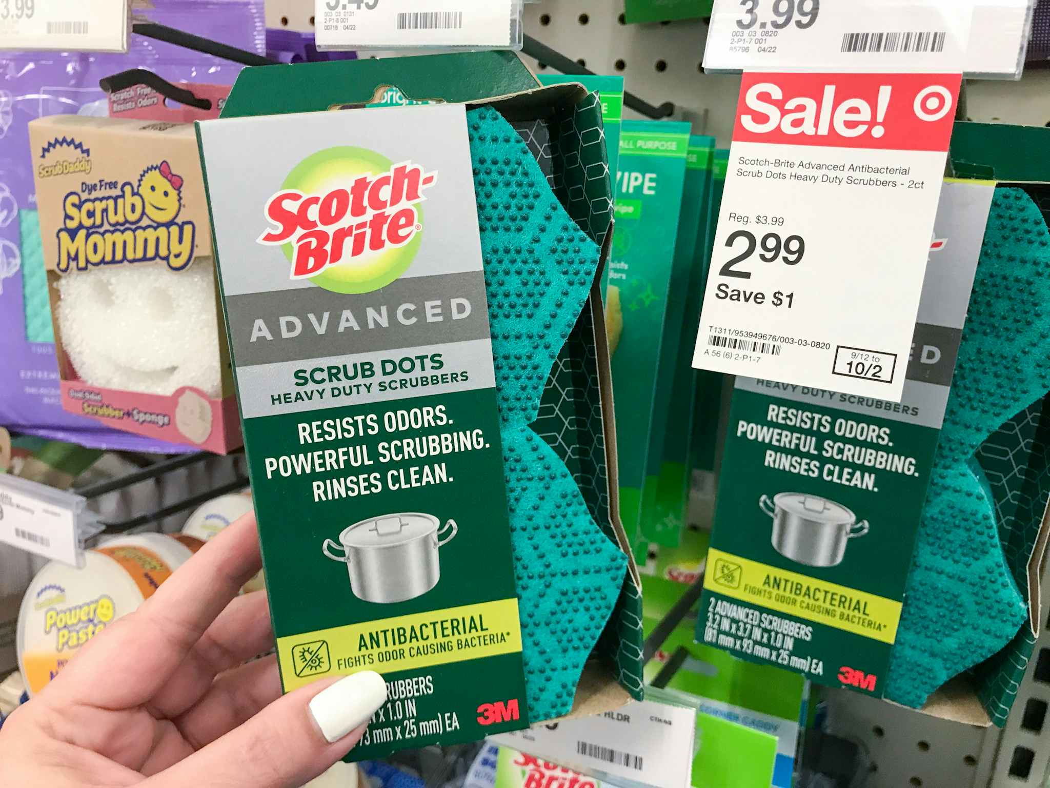 hand holding scotch-brite advanced scrub dots in front of target sale tag