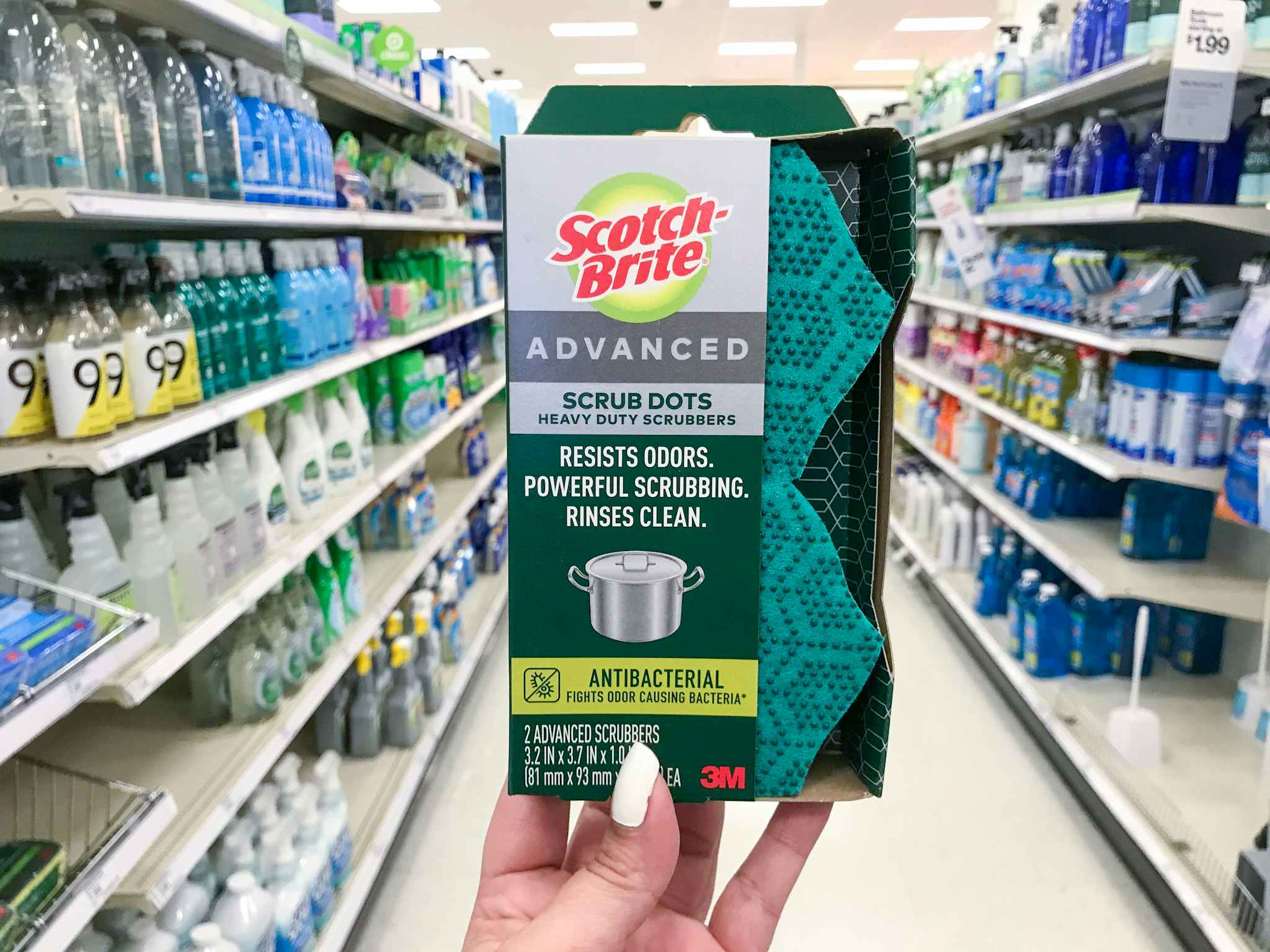 hand holding scotch-brite advanced scrub dots in an aisle at target