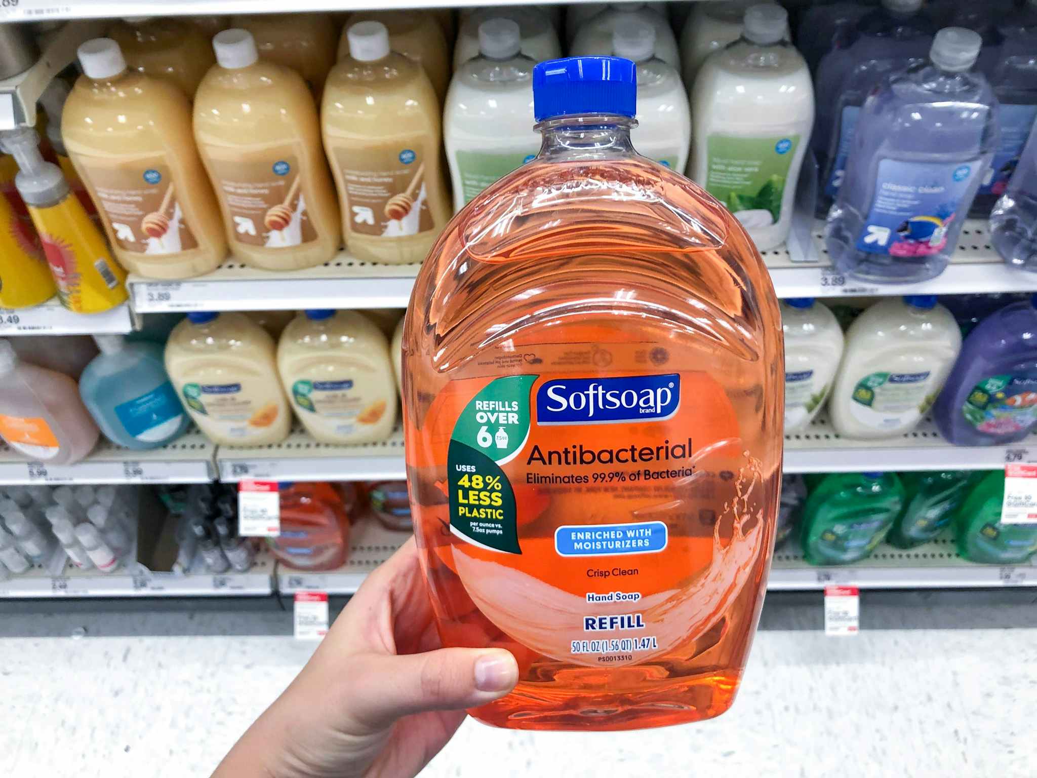 hand holding a softsoap hand soap refill at target