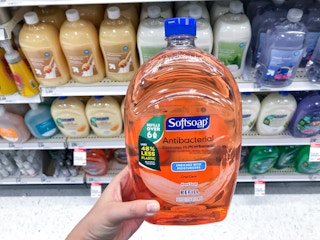 hand holding a softsoap hand soap refill at target