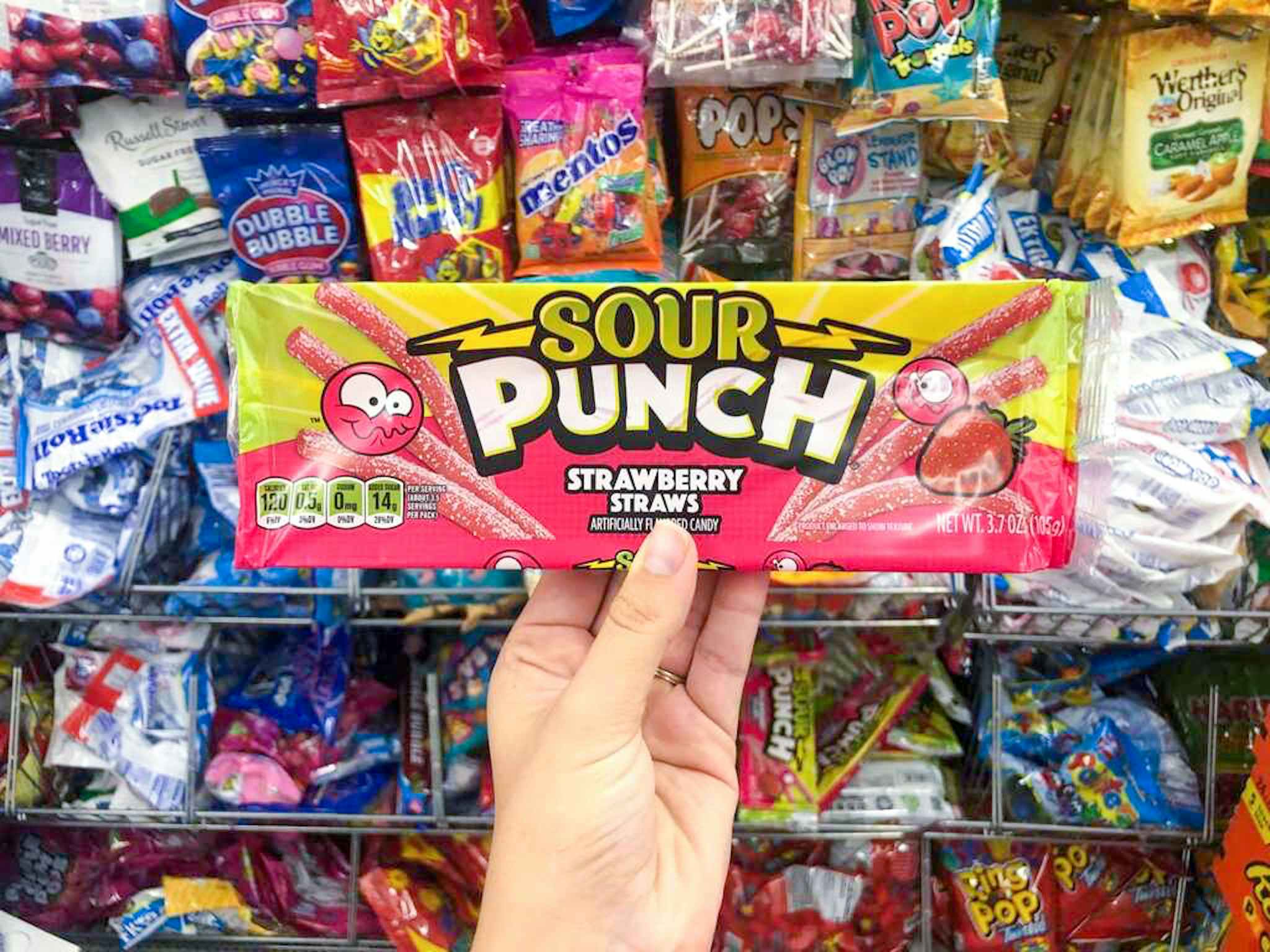 hand holding sour punch straws at dollar tree
